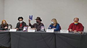 Panelists for "The DMV in Speculative Fiction" with Jean Marie Ward (M), Brick Barrientos, T. C. Weber, Randee Dawn, and Martin Berman-Gorvine.